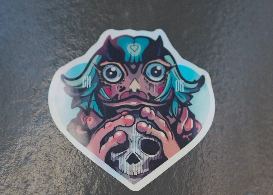 Frog Invader sticker on a wet wall